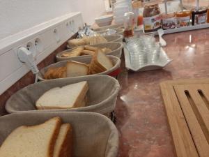 a kitchen filled with lots of trays of food at Cat'Hotel in Bourg-de-Péage