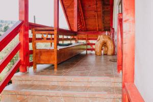 an open door to a porch with a chair on it at La Casieru in Bilbor