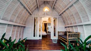 a room with a bed and a couch in a room at Elysium Bingin in Uluwatu