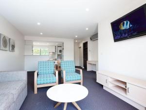 a living room with a couch and two chairs and a table at Pacific Blue 245-265 Sandy Point Rd - Dual Key Access, air conditioned unit with resort facilities and linen supplied in Salamander Bay