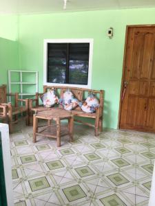 a room with a couch and a table and a window at Mabuhay Thresher Dive Resort in Malapascua Island