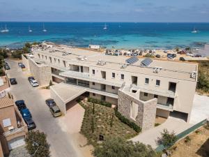 an aerial view of a building with the ocean in the background at Residence Saletta Mare in LʼÎle-Rousse