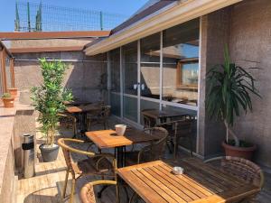 an outdoor patio with wooden tables and chairs at Era Palace Hotel in Istanbul
