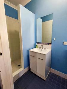 a bathroom with a sink and a mirror at Dunsborough Beach Lodge in Dunsborough