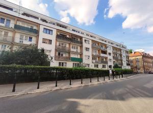 a large white building on the side of a street at Comfortable Studio Old Town/New City in Warsaw