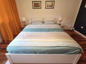 a large bed in a bedroom with two lamps at Comfortable Studio Old Town/New City in Warsaw