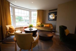 a living room filled with furniture and a window at The Falcon Hotel in Northampton