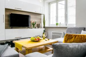 a living room with a table and a tv at Apartment in downtown in Olomouc