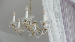 a chandelier in a room with a curtain at govienna - City Center Apartments in Vienna