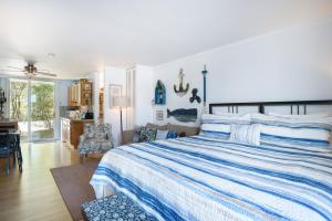 a bedroom with a blue and white bed and a desk at Waterside Suites in Saugatuck