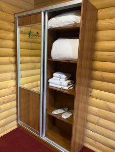 Cette chambre comprend un placard avec des serviettes et un lit. dans l'établissement Аквапарк Глухомань, à Poltava