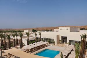 - Vistas a un complejo con piscina y palmeras en Kedma by Isrotel Design en Sede Boqer