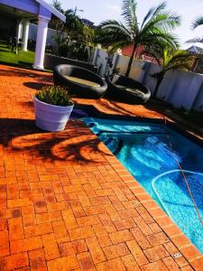 a swimming pool with three toilets in a house at Marilyn Boutique Hotel in Durban