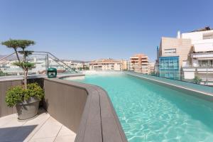 a large swimming pool on top of a building at Hotel Lima - Adults Recommended in Marbella