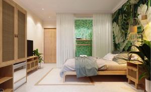 a bedroom with a bed and a green wall at The wiltons hotel in Nam Ðịnh