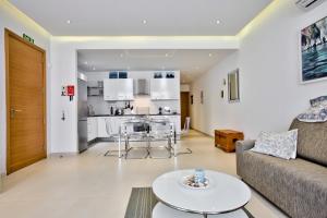 a living room with a couch and a table at Bright and central 2 bedroom apartment in Sliema in Sliema