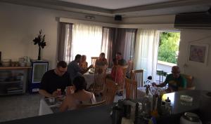 a group of people sitting at tables in a room at Alkyonides Boutique Hotel in Kremasti