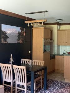 a kitchen and dining room with a table and chairs at Arc 1950 aux pieds des pistes in Arc 1950