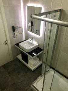 a bathroom with a sink and a shower at Era Palace Hotel in Istanbul