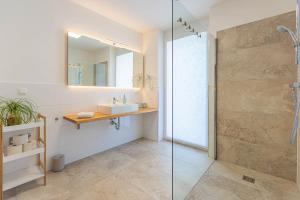 a bathroom with a glass shower and a sink at Alpine Appartement Top 2 by AA Holiday Homes in Tauplitz