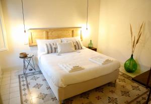 Łóżko lub łóżka w pokoju w obiekcie DimorAruci - Ospitalità Siciliana