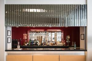 a bar with a lot of alcohol bottles at Lancaster Hall Hotel in London