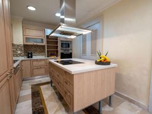 a kitchen with a island with a bowl of fruit on it at Rixos Premium Belek - The Land of Legends Access in Belek