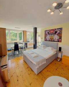 a bedroom with a large bed and a dining room at SunRoom Szczecin in Szczecin