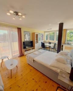 a bedroom with a large bed and a dining room at SunRoom Szczecin in Szczecin