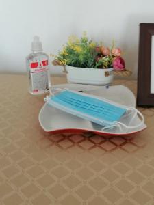 a table with a surfboard and a bottle of water at Danube Apartment in Belgrade