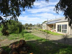 a house with a gravel road in front of it at Meander Retreat - The Green Room in Springton