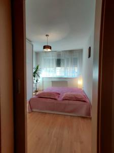 a bedroom with a large red bed in a room at Lucky Home Timisoara 1 in Timişoara