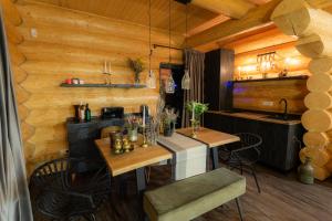 a dining room with two tables and a kitchen at Resort Back To Nature in Bran