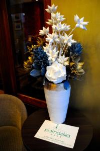a vase filled with flowers on a table at Boutique Hotel Parnassia in Arachova