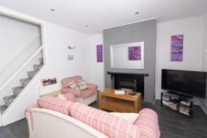 a living room with two couches and a television at Entire House - 2 Bedroom - 3 Bed - Free wifi - TV in Clayton le Moors