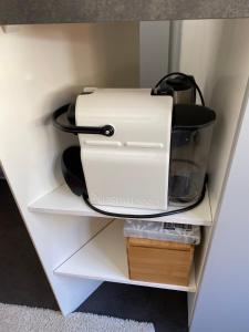 a white appliance sitting on top of a shelf at Studio Lac Noir in Chandolin