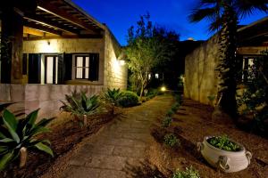 a house with a pathway in front of a building at Miramare Residence in Favignana