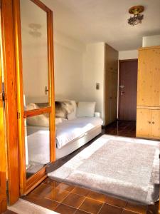 a bedroom with a bunk bed and a mirror at La Sorgente - Immersi nella natura in Limone Piemonte