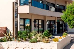 a building with a sign in front of it at Cactus Hotel in Rhodes Town