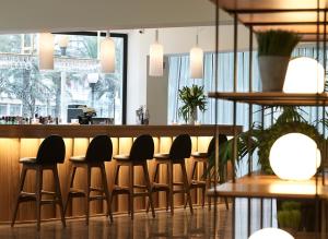 a bar with a row of chairs in a restaurant at Cactus Hotel in Rhodes Town