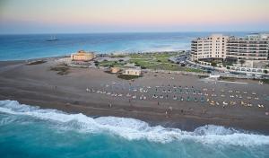 an aerial view of a beach with buildings and the ocean at Cactus Hotel in Rhodes Town