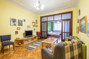 a living room with a couch and a tv at PhotoHome - Aristocratic Center of Sofia in Sofia