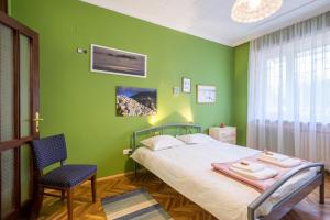 a bedroom with a bed and a green wall at PhotoHome - Aristocratic Center of Sofia in Sofia