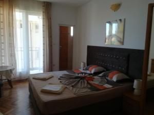 a bedroom with a bed with a bow on it at Guest House Stenli in Primorsko