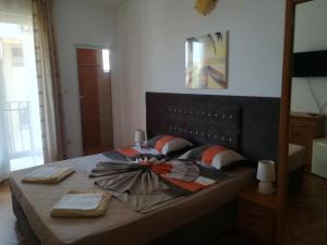 a bedroom with a bed with a bow on it at Guest House Stenli in Primorsko