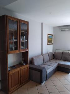 a living room with a couch and a cabinet at CASA DI ALFEO in Perugia