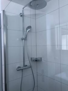 a shower with a glass door with a shower head at Chalet Wanda in Saas-Fee