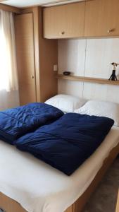 מיטה או מיטות בחדר ב-AMELAND-Nes-Duinoord: Stacaravan (chalet) + fietsen direct aan zee!
