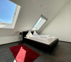 Schlafzimmer mit einem schwarzen Bett und einem roten Teppich in der Unterkunft Vis-Ahr-Vis Country in Bad Neuenahr-Ahrweiler