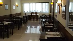 a restaurant with tables and chairs in it at Hostal Conde Rey in Bandeira